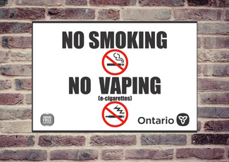 Provincial No Smoking No Vaping sign on brick wall.