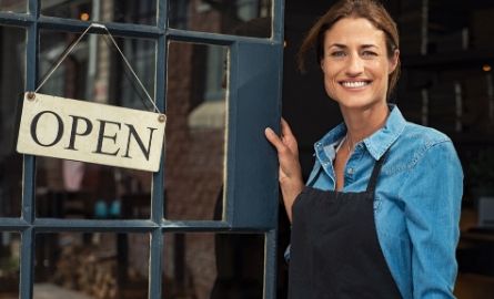 Woman with open business sign