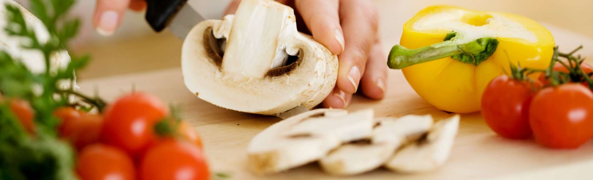 Hands slicing a mushroom