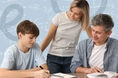 A youth sits at a table writing in a notebook while two adults look on.